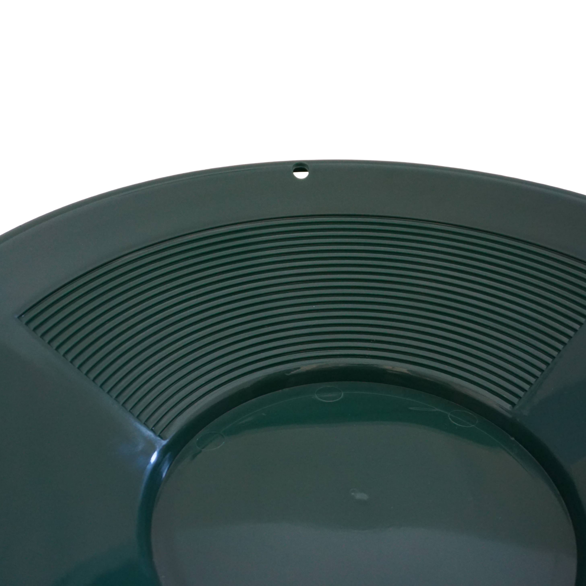 Close-up of fine riffles inside NubuClo gold prospecting pan.
