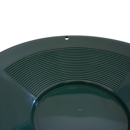 Close-up of fine riffles inside NubuClo gold prospecting pan.
