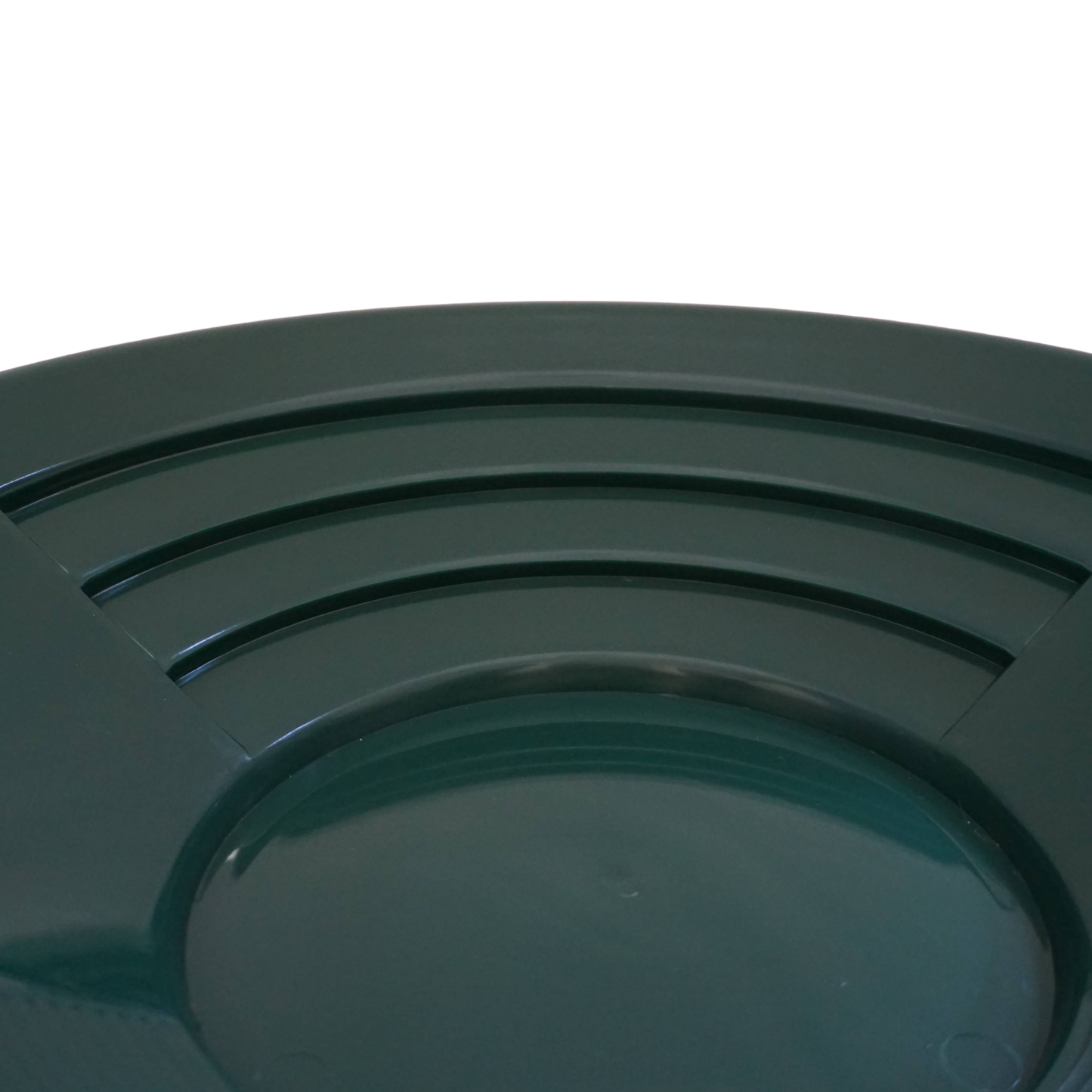 Close-up of deep riffles in NubuClo gold pan for efficient material separation.

