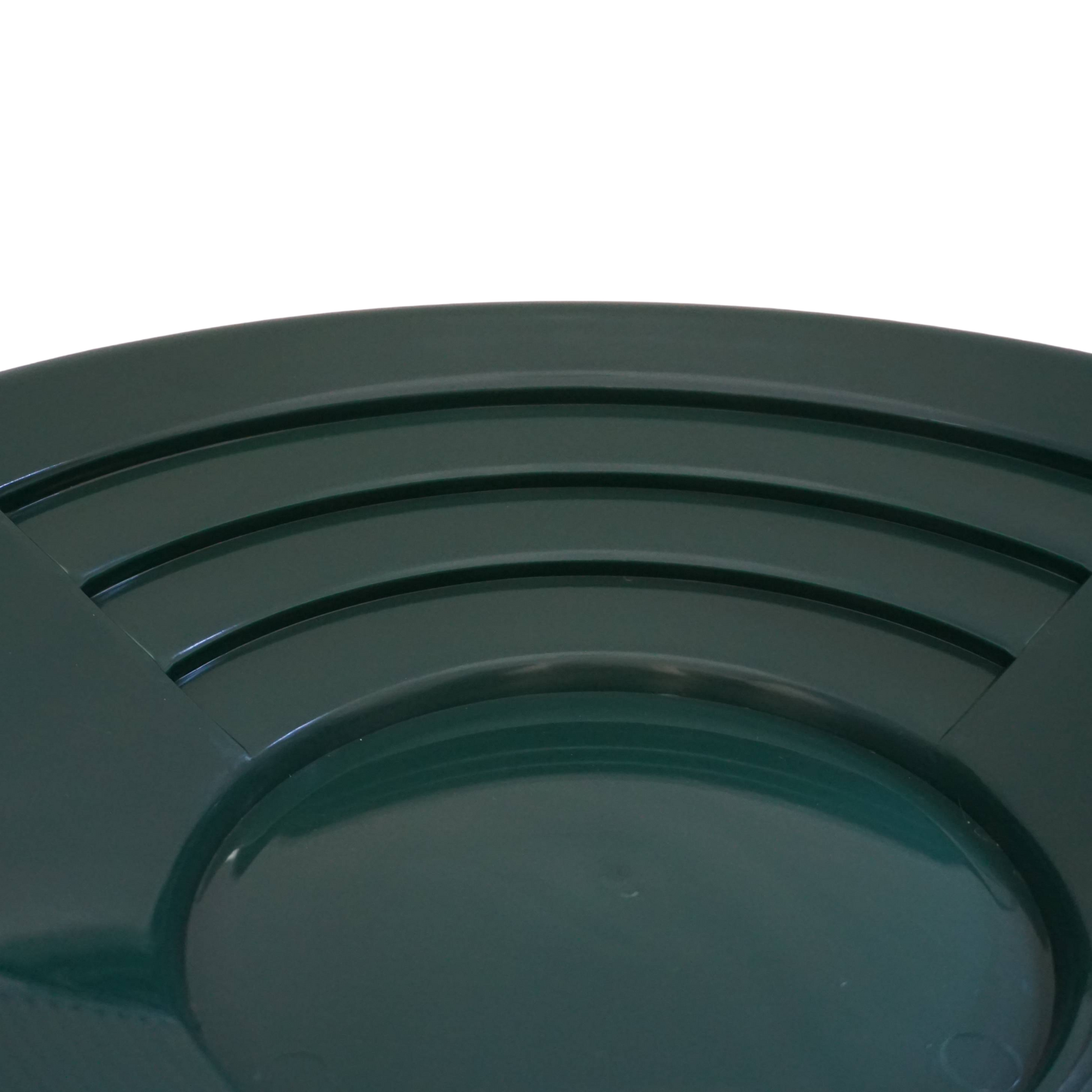 Close-up of deep riffles in NubuClo gold pan for efficient material separation.
